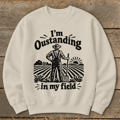 Cream sweatshirt with "I'm Oustanding in my field" text and farmer graphic.