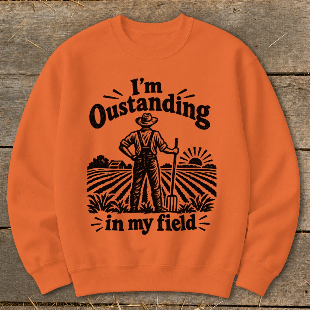 Orange sweatshirt with farmer graphic and text "I'm Oustanding in my field".