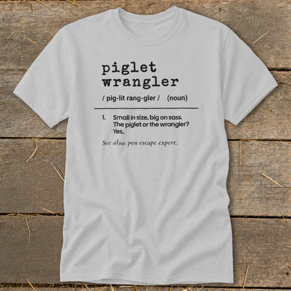 Light grey t-shirt with "piglet wrangler" definition printed in black text.