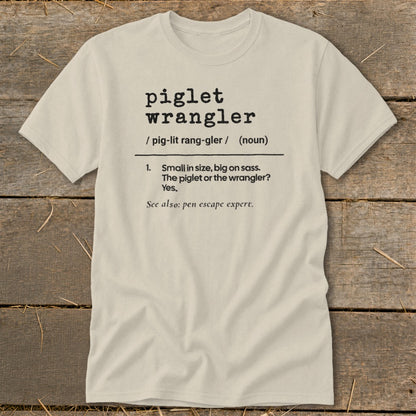 Light tan t-shirt with "piglet wrangler" definition.