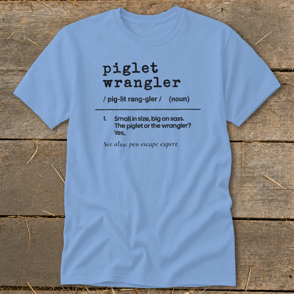 Light blue t-shirt with black text defining "piglet wrangler" as small, sassy, and a pen escape expert.