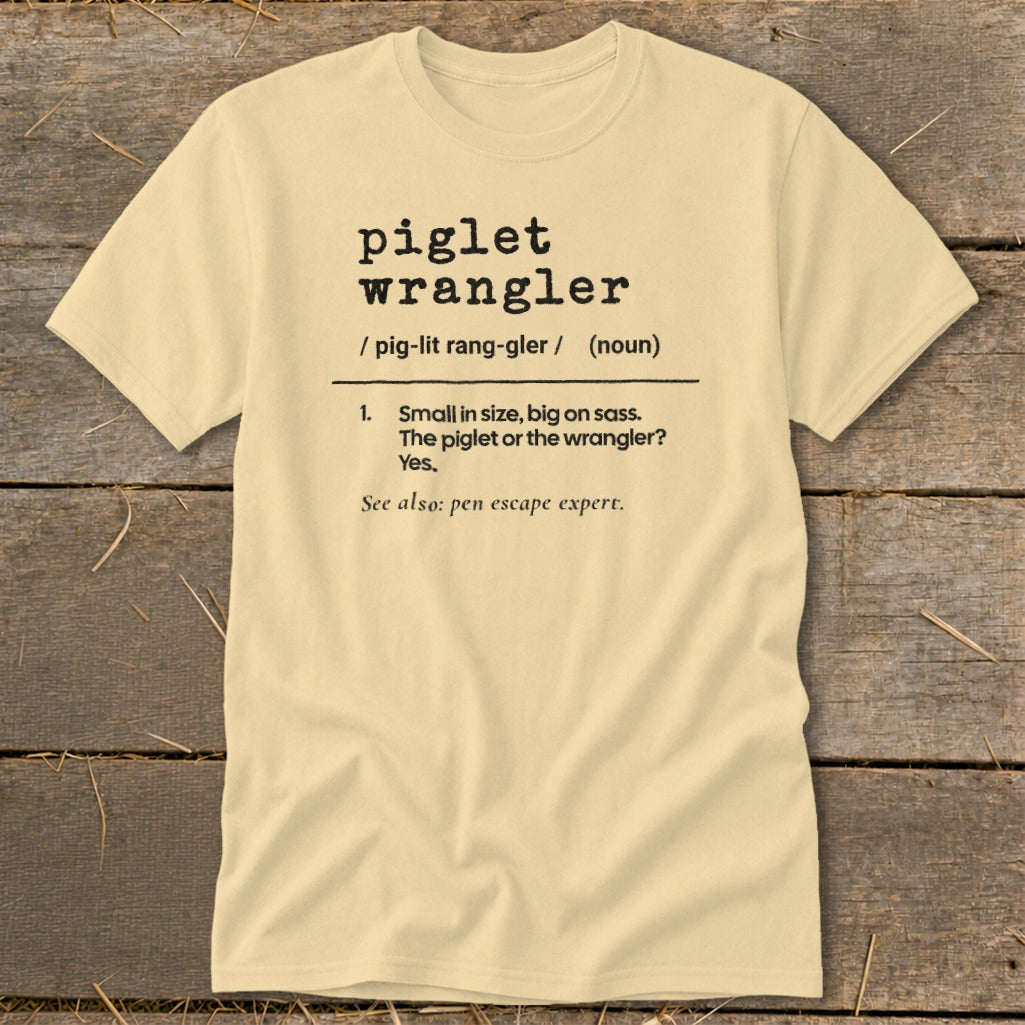 Light yellow t-shirt with "piglet wrangler" definition.