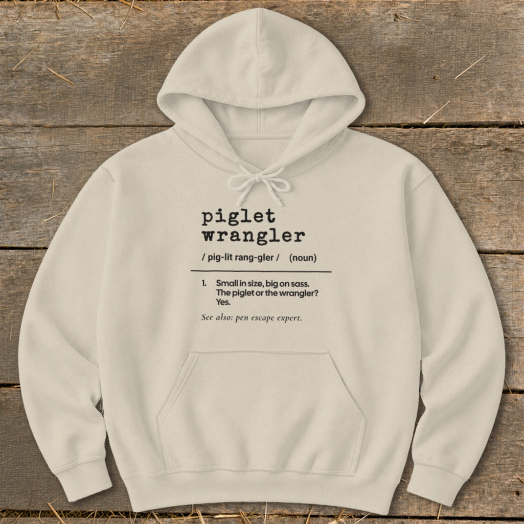 Cream hoodie with "piglet wrangler" definition text and a kangaroo pocket.