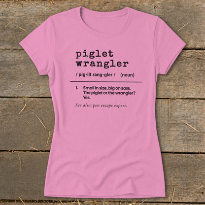 Pink t-shirt with "piglet wrangler" definition: "Small in size, big on sass."