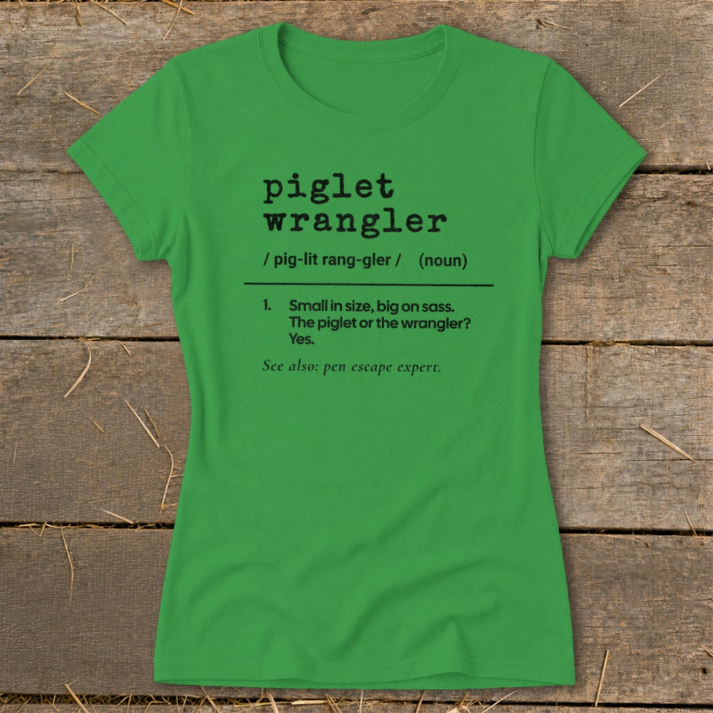 Green t-shirt with black text: "piglet wrangler", definition, and "pen escape expert".