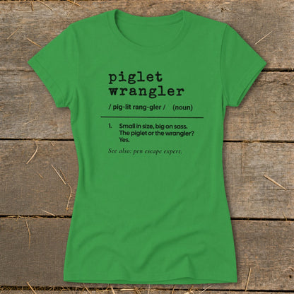 Green t-shirt with black text: "piglet wrangler", definition, and "pen escape expert".