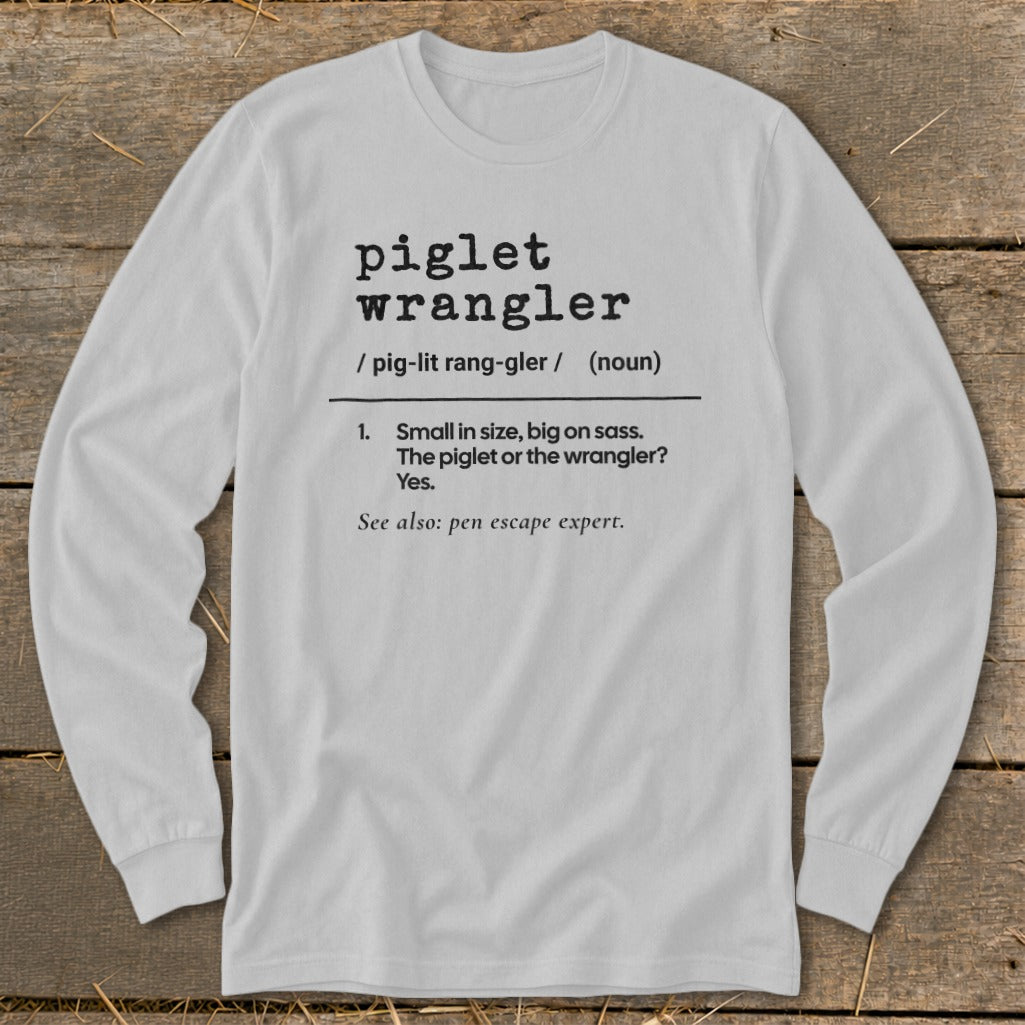 White long-sleeve shirt with "piglet wrangler" definition printed on it.