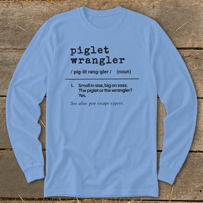Light blue long-sleeve shirt with "piglet wrangler" definition printed in black text.