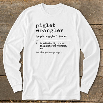 White long sleeve shirt with "piglet wrangler" definition printed on it.