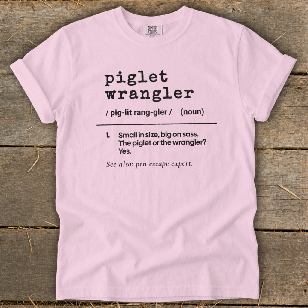 Pink t-shirt with "piglet wrangler" dictionary definition, "pen escape expert."