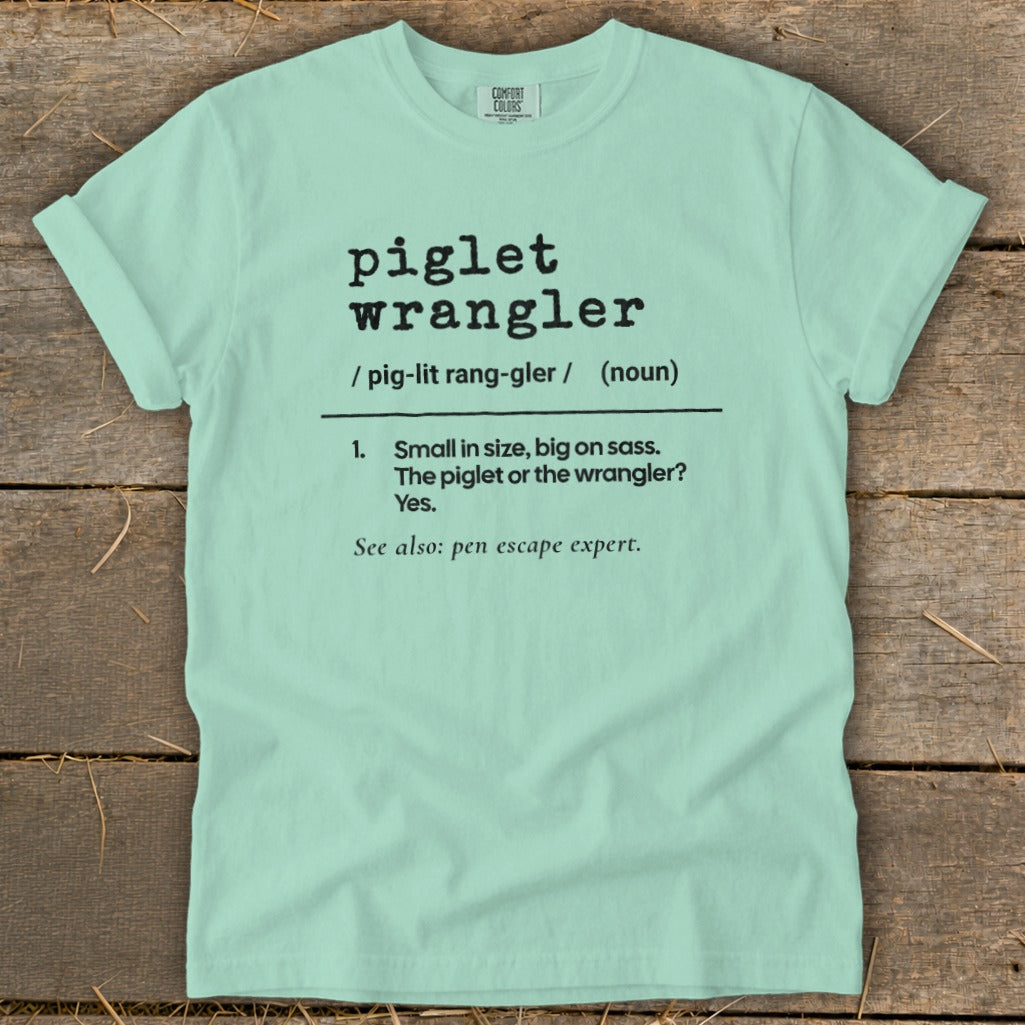 Light blue t-shirt with "piglet wrangler" definition in black text.