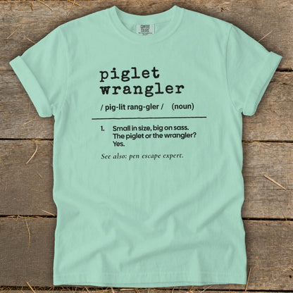 Light blue t-shirt with "piglet wrangler" definition in black text.