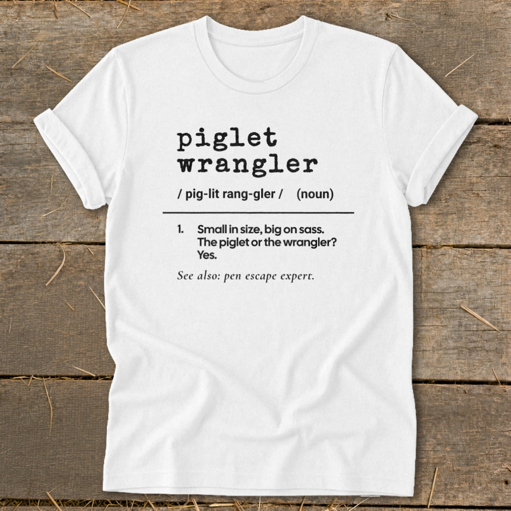 White t-shirt with "piglet wrangler" definition and "pen escape expert" text.