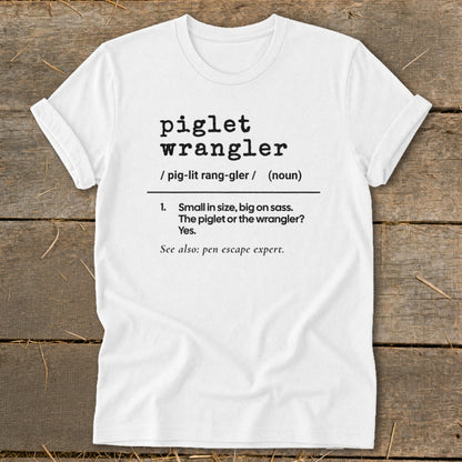 White t-shirt with "piglet wrangler" definition and "pen escape expert" text.