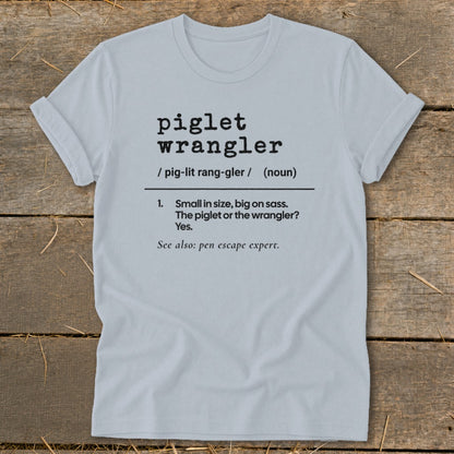 Light blue t-shirt with "piglet wrangler" definition including pronunciation and sassy description.