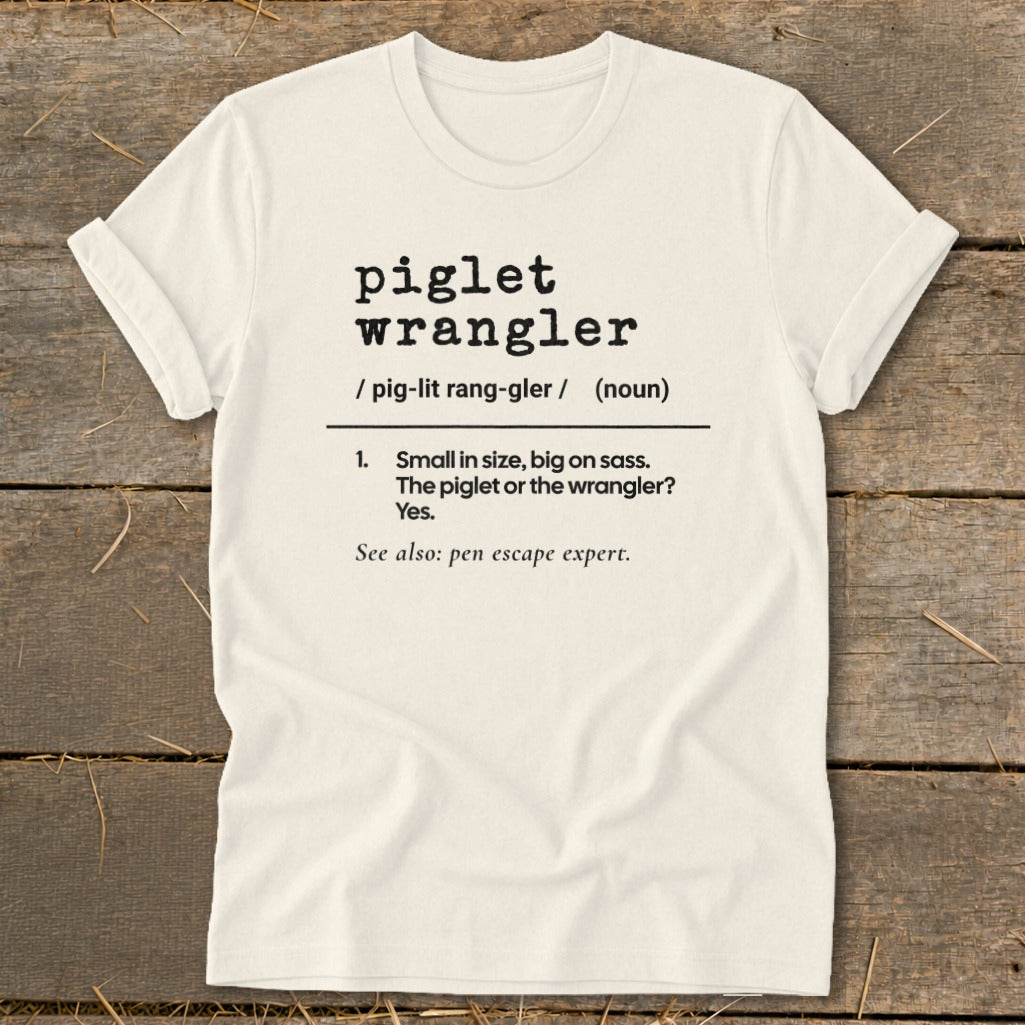 Piglet Wrangler definition t-shirt: Small in size, big on sass. Pen escape expert.