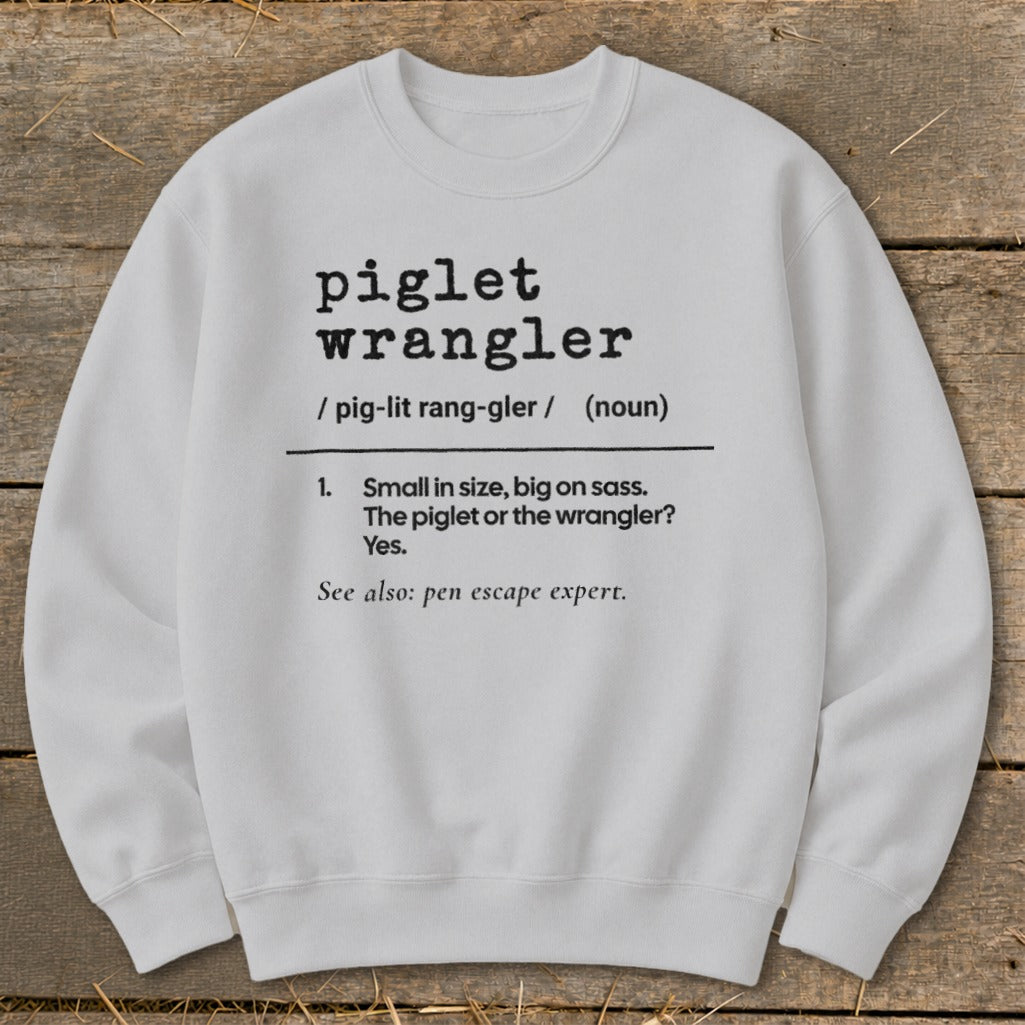 White sweatshirt with dictionary definition of "piglet wrangler" and "pen escape expert."