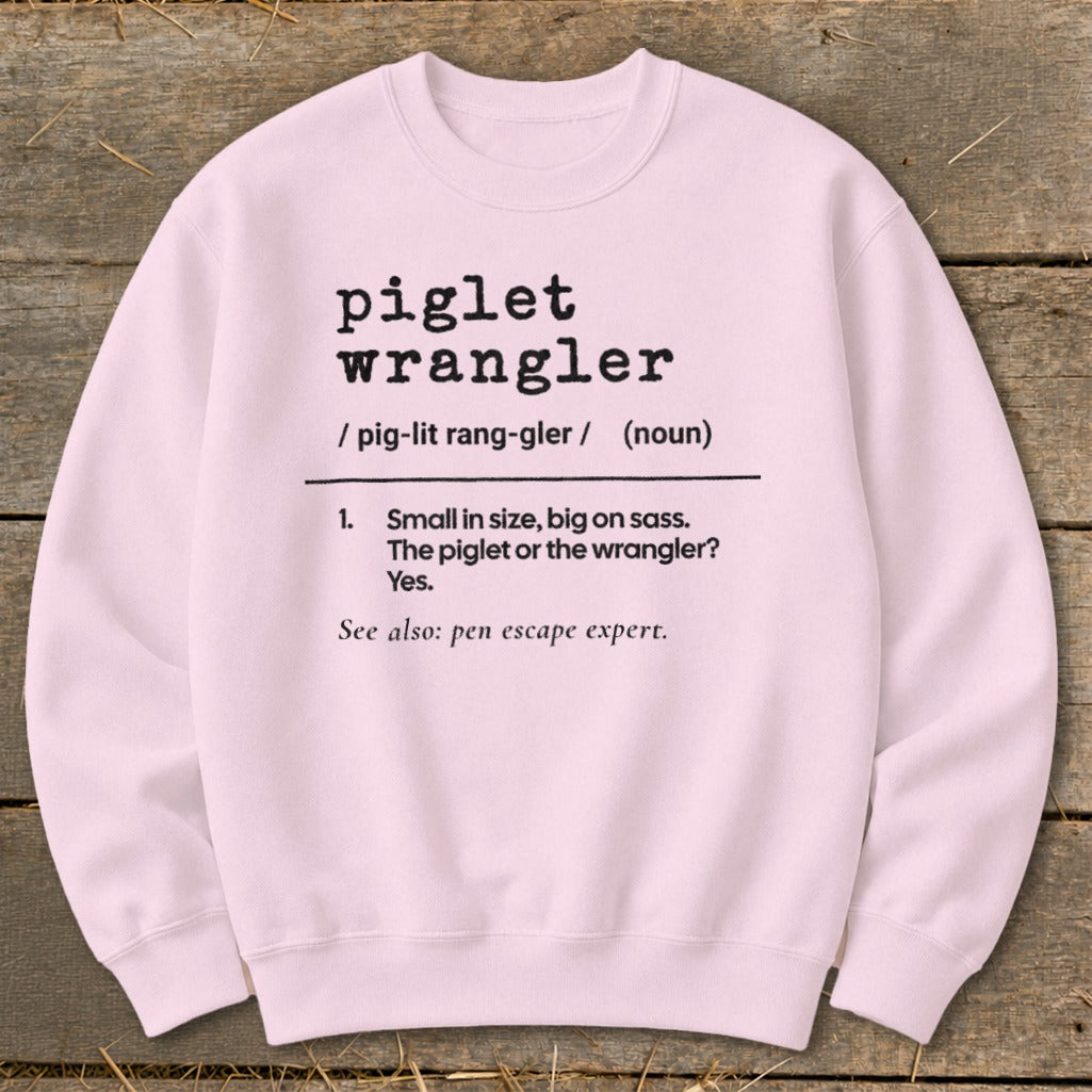 Pink sweatshirt with "piglet wrangler" definition and humorous description.
