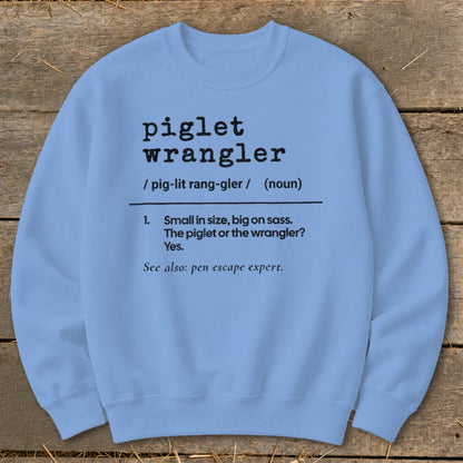 Light blue sweatshirt with "piglet wrangler" definition text.
