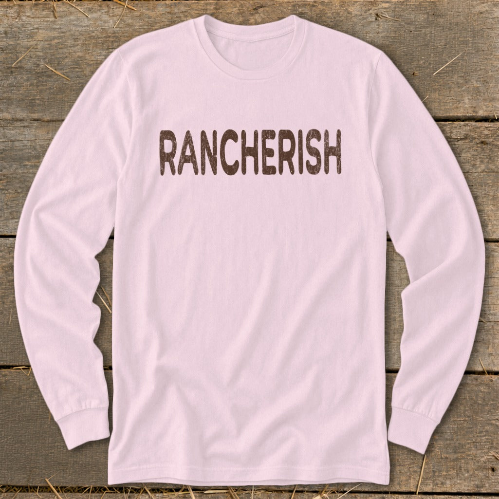 Pink long sleeve shirt with "RANCHERISH" printed in brown.