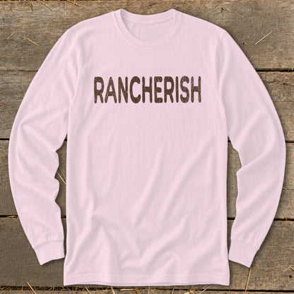 Pink long sleeve shirt with "RANCHERISH" printed in brown.