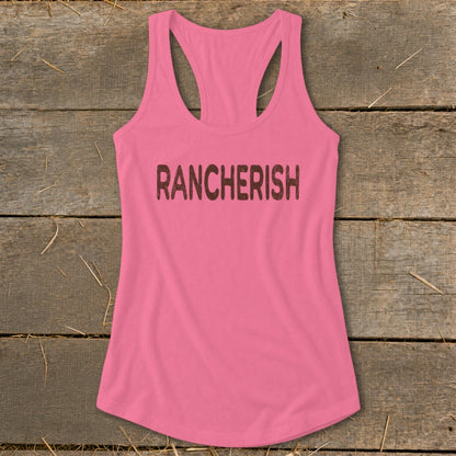 Pink racerback tank top with "RANCHERISH" text printed in distressed brown lettering.