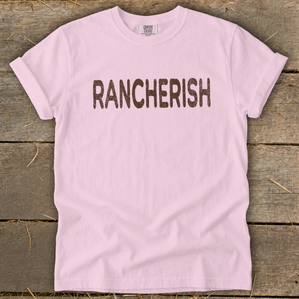 Pink t-shirt with "RANCHERISH" in brown distressed text.