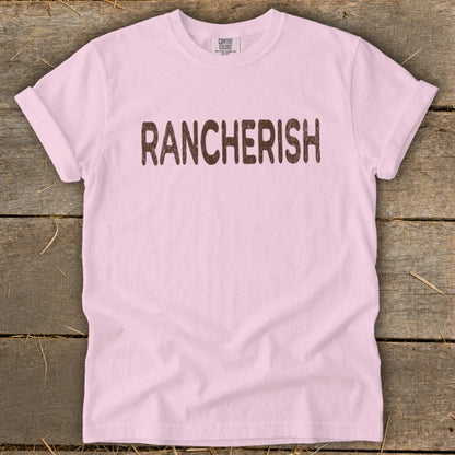 Pink t-shirt with "RANCHERISH" in brown distressed text.