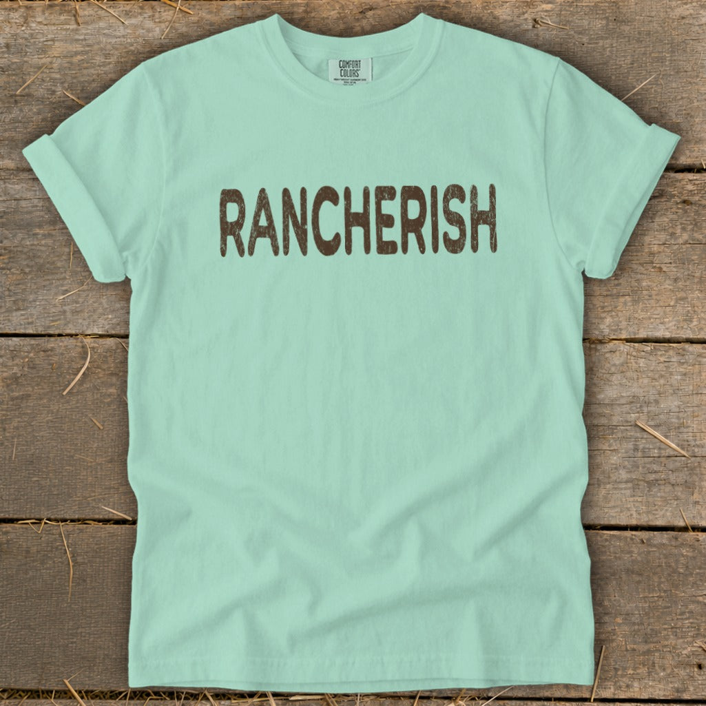 Light blue t-shirt with "RANCHERISH" printed in brown distressed letters.