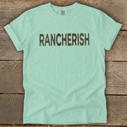 Light blue t-shirt with "RANCHERISH" printed in brown distressed letters.