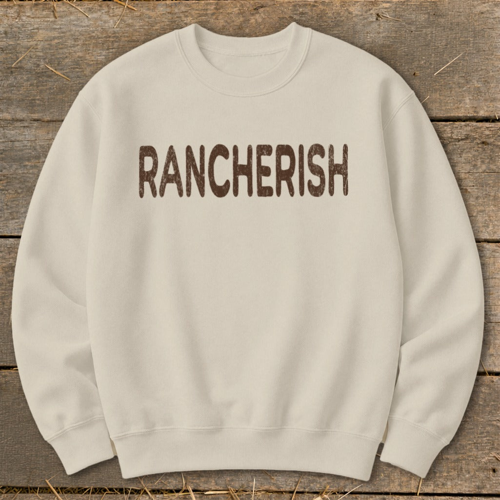 Cream sweatshirt with "RANCHERISH" text in distressed brown letters.