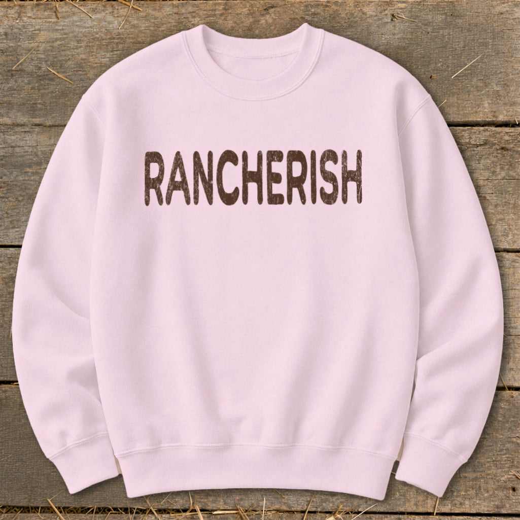 Light pink crewneck sweatshirt with "RANCHERISH" in brown distressed text.