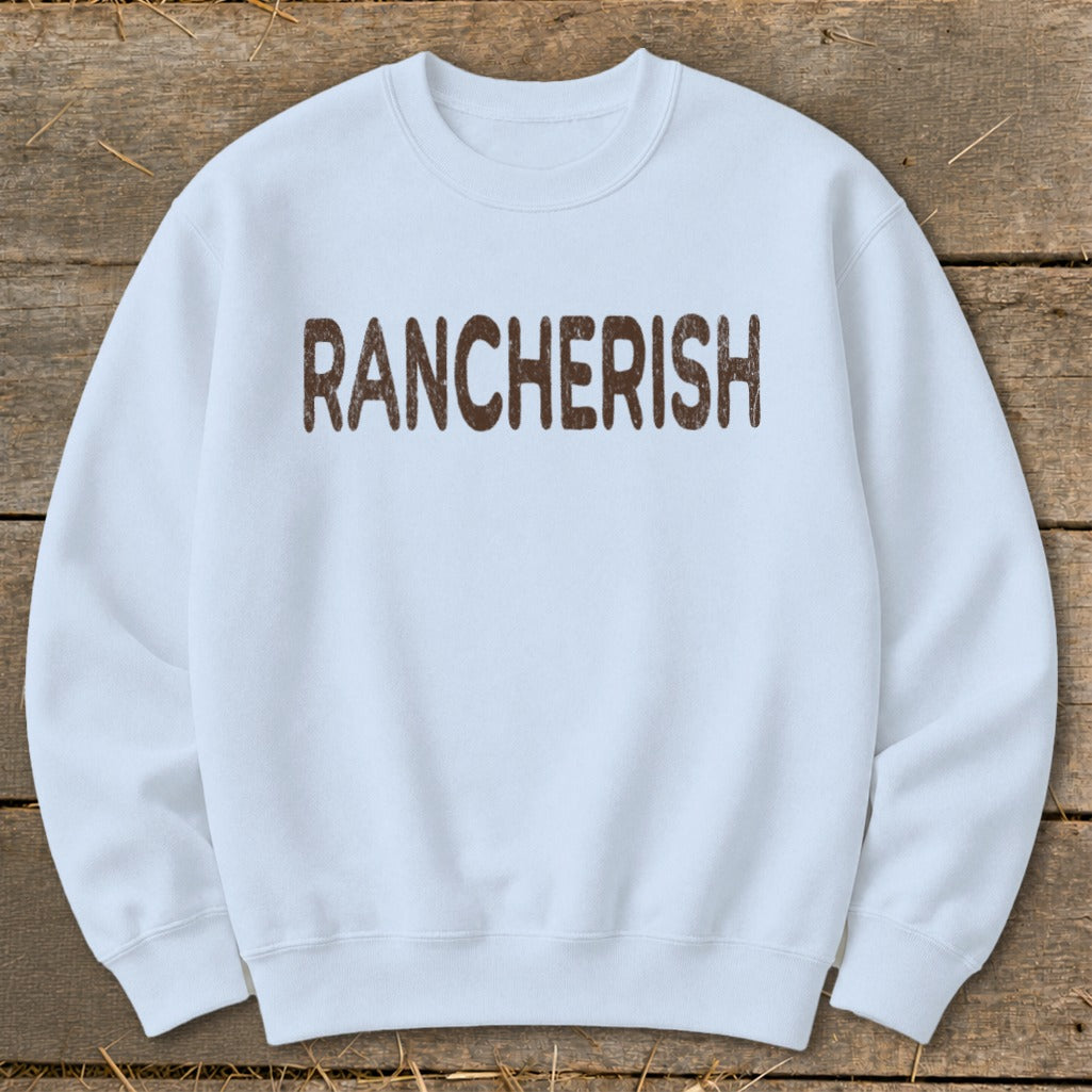 White sweatshirt with "RANCHERISH" printed in brown letters.