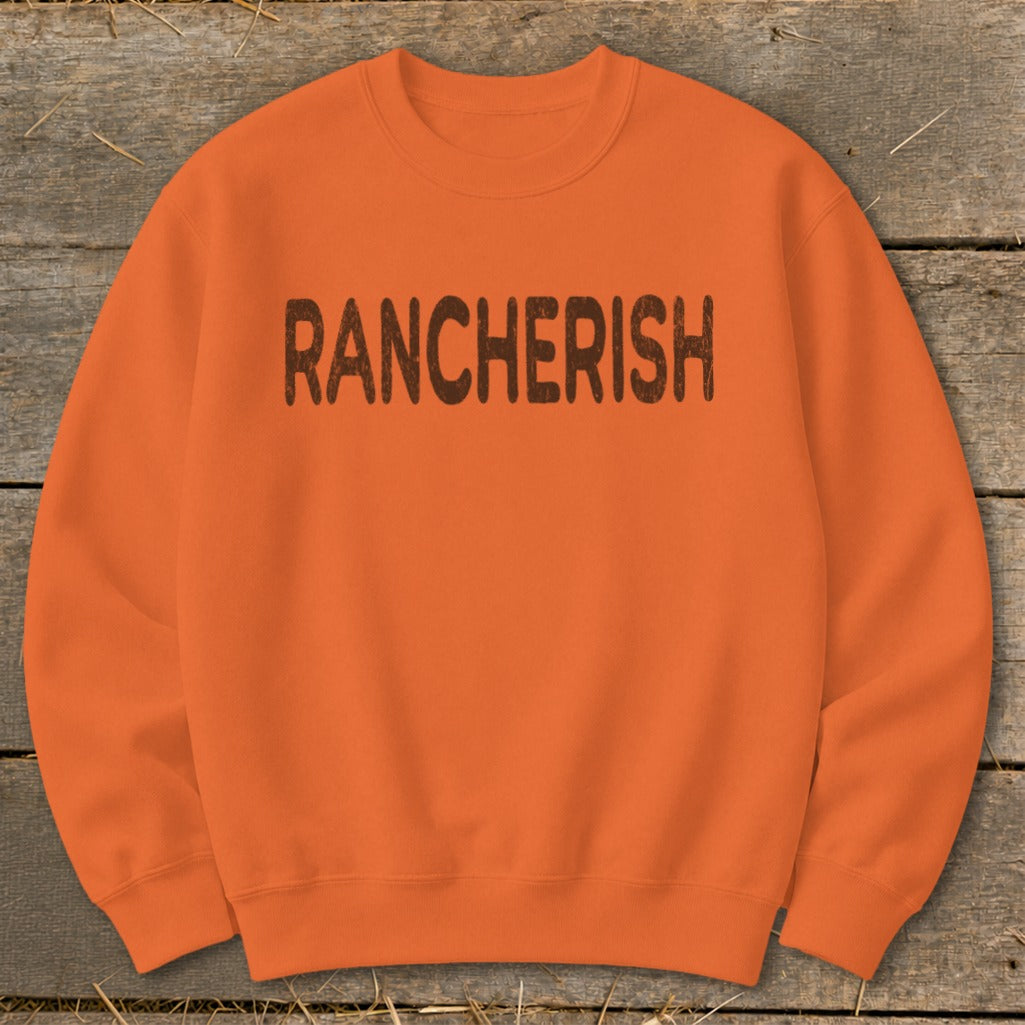 Orange crewneck sweatshirt with "RANCHERISH" in brown distressed lettering.