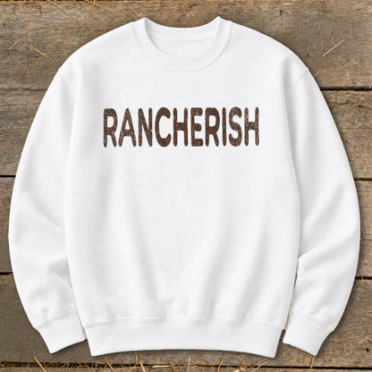 White crewneck sweatshirt with brown "RANCHERISH" text.