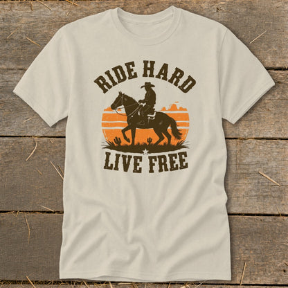 T-shirt graphic with cowboy on horseback, desert sunset, and text "RIDE HARD LIVE FREE".