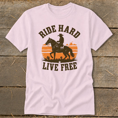 Light pink t-shirt with distressed cowboy riding a horse silhouette and "Ride Hard Live Free" text.