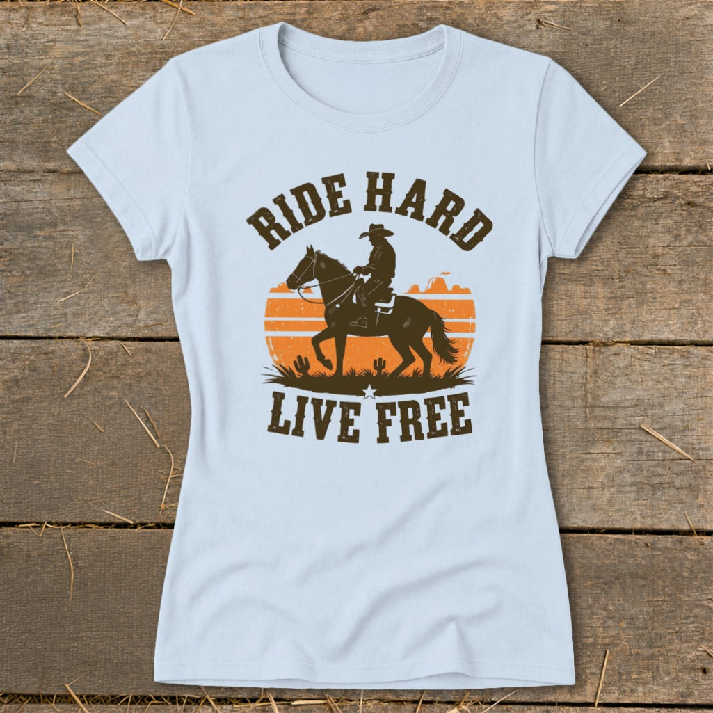 Light blue t-shirt with a cowboy on horseback and the words "RIDE HARD LIVE FREE."