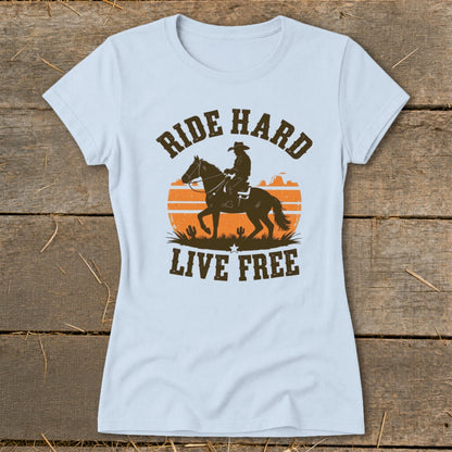 Light blue t-shirt with a cowboy on horseback and the words "RIDE HARD LIVE FREE."