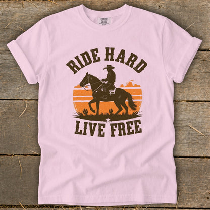 Pink t-shirt with "RIDE HARD LIVE FREE" text and cowboy on horseback silhouette.