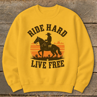 Yellow sweatshirt with cowboy on horse, sunset, and "Ride Hard Live Free" text.