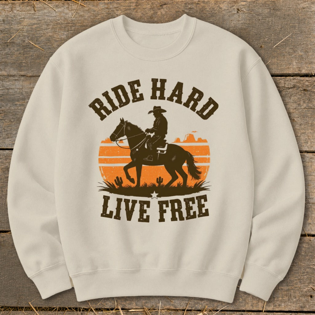 Sweatshirt with a silhouette of a cowboy on a horse, orange sunset, and text "RIDE HARD LIVE FREE."