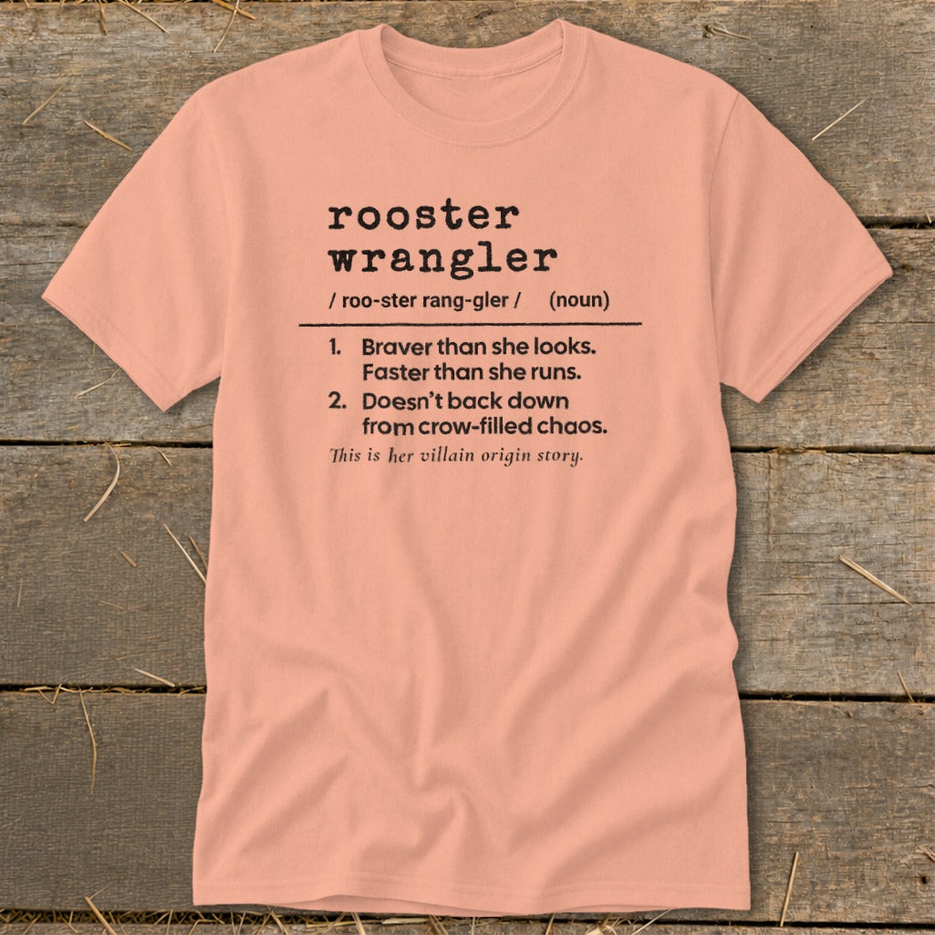 Peach t-shirt with definition of "rooster wrangler" and "villain origin story."