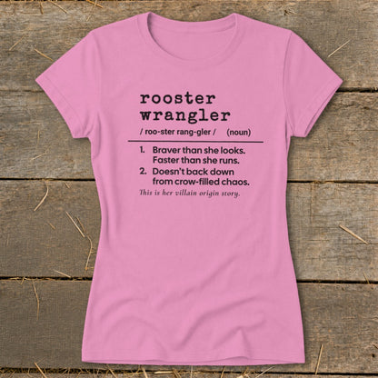 Pink t-shirt with "rooster wrangler" definition and "villain origin story" text.