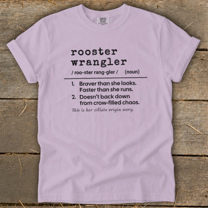 Lavender t-shirt with "rooster wrangler" definition and "villain origin story" text.