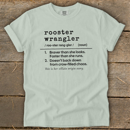 Light blue t-shirt with "rooster wrangler" definition and "villain origin story" text.