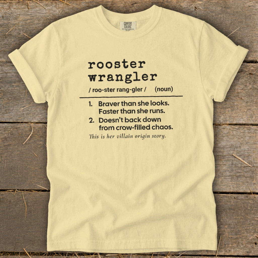 Light yellow t-shirt with black text defining "rooster wrangler."