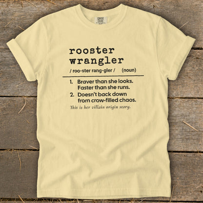 Light yellow t-shirt with black text defining "rooster wrangler."