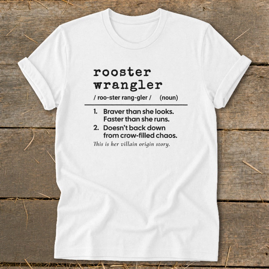 White t-shirt with "rooster wrangler" definition and "villain origin story" text.