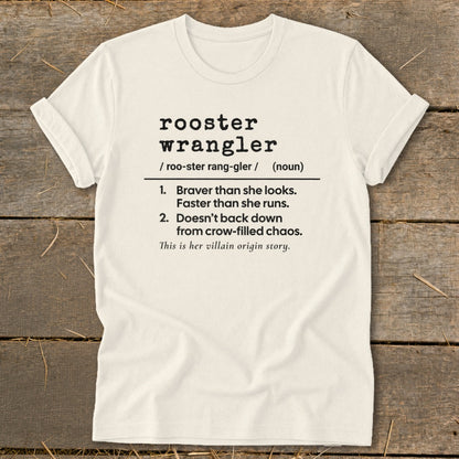Cream t-shirt with black text defining "rooster wrangler" and its traits.